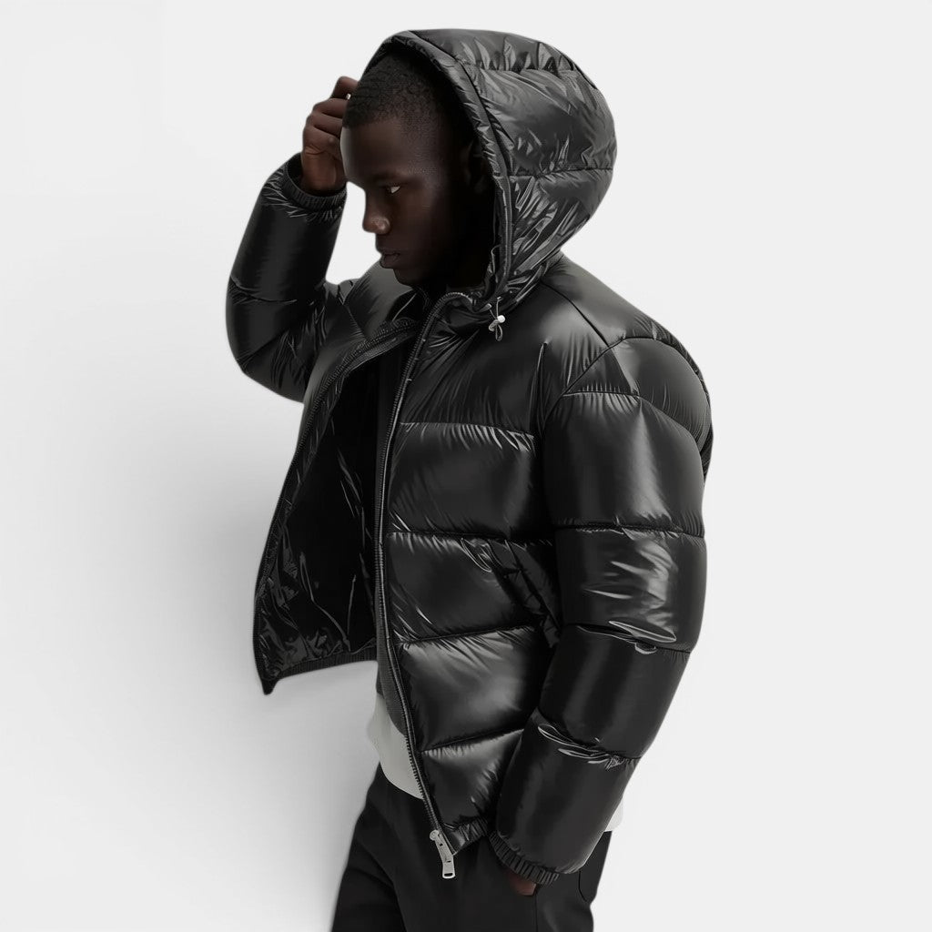 Allzom black puffer jacket with hood, zip closure and shiny finish. Model wearing casual outerwear.