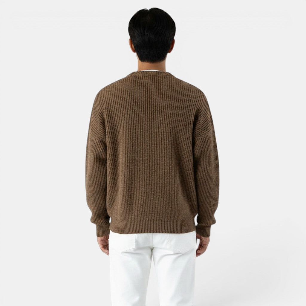 Allzom men's brown chunky-knit crew-neck sweater with ribbed texture. Model wearing white trousers.