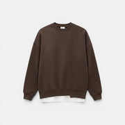 Allzom men's loose round-neck pullover sweater in dark brown. Features a layered effect with a white t-shirt hem peeking out.