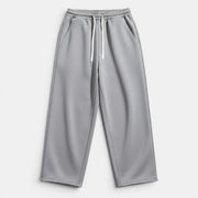 Calças retas cinzentas de cintura subida Allzom com cordão branco e bolsos laterais. Tecido liso.