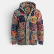 Casaco de malha Allzom com capuz e padrão patchwork em tons de azul, rosa, laranja e cinza. Detalhes em croché e botões de madeira.
