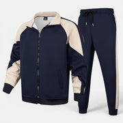 Conjunto de fato de treino Allzom em azul-marinho e bege, com fecho de correr e calças de cintura subida.