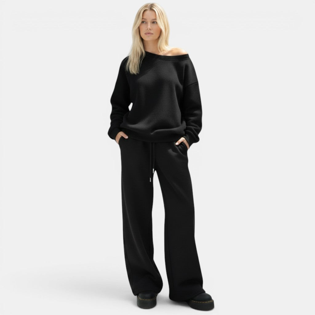 Conjunto desportivo Allzom de mulher com capuz solto e calças largas pretas em malha.