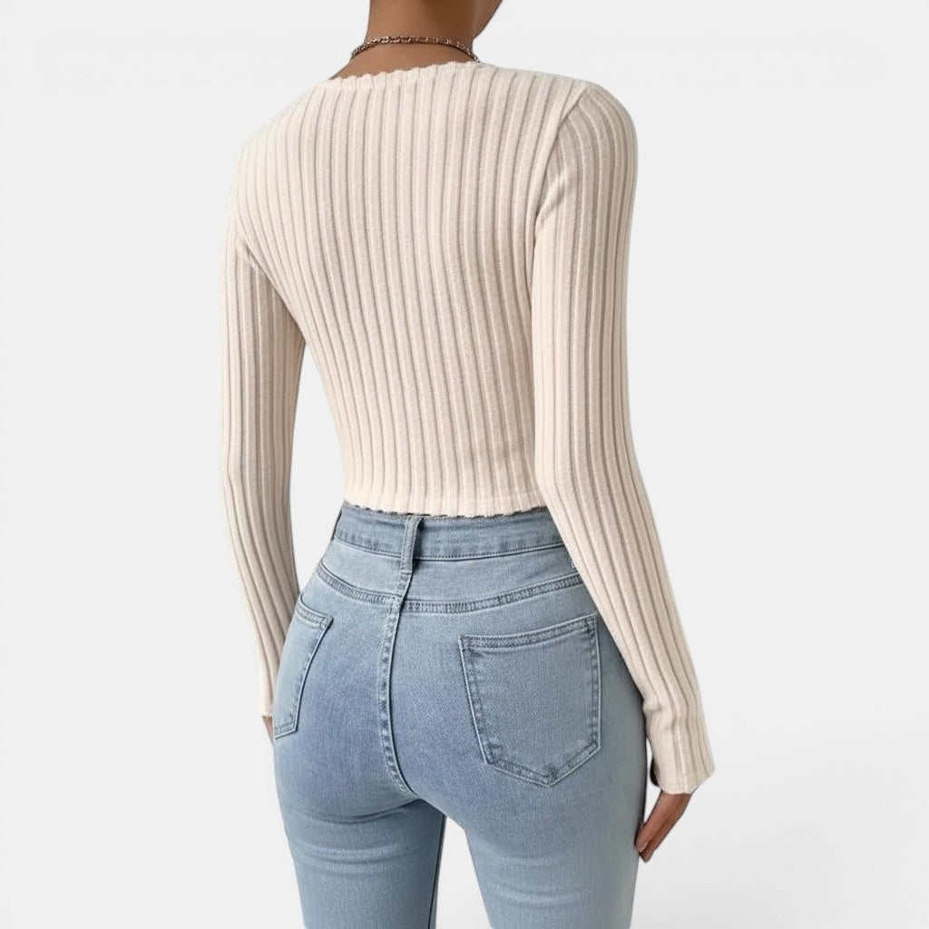 Allzom cream ribbed knit long sleeve slim-fit sweater with deep V-neck, paired with light wash jeans.