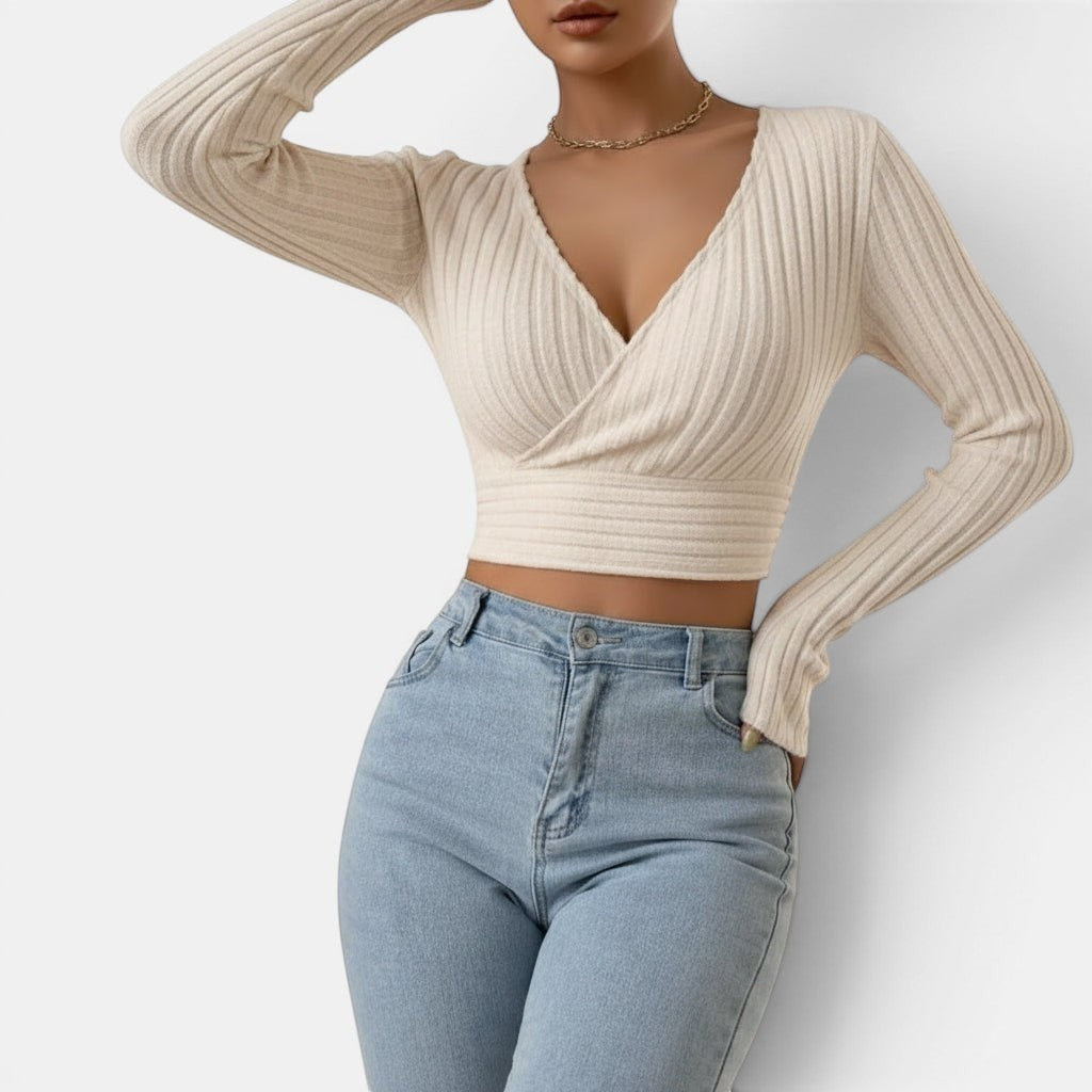 Allzom cream ribbed knit deep V-neck long sleeve slim-fit cropped sweater worn by a model with light blue jeans.