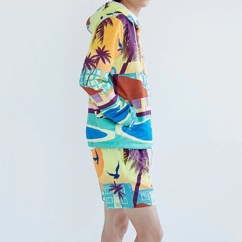 Allzom Men's two-piece set with a colourful graphic print featuring palm trees and buildings on a hooded sweater and matching shorts.