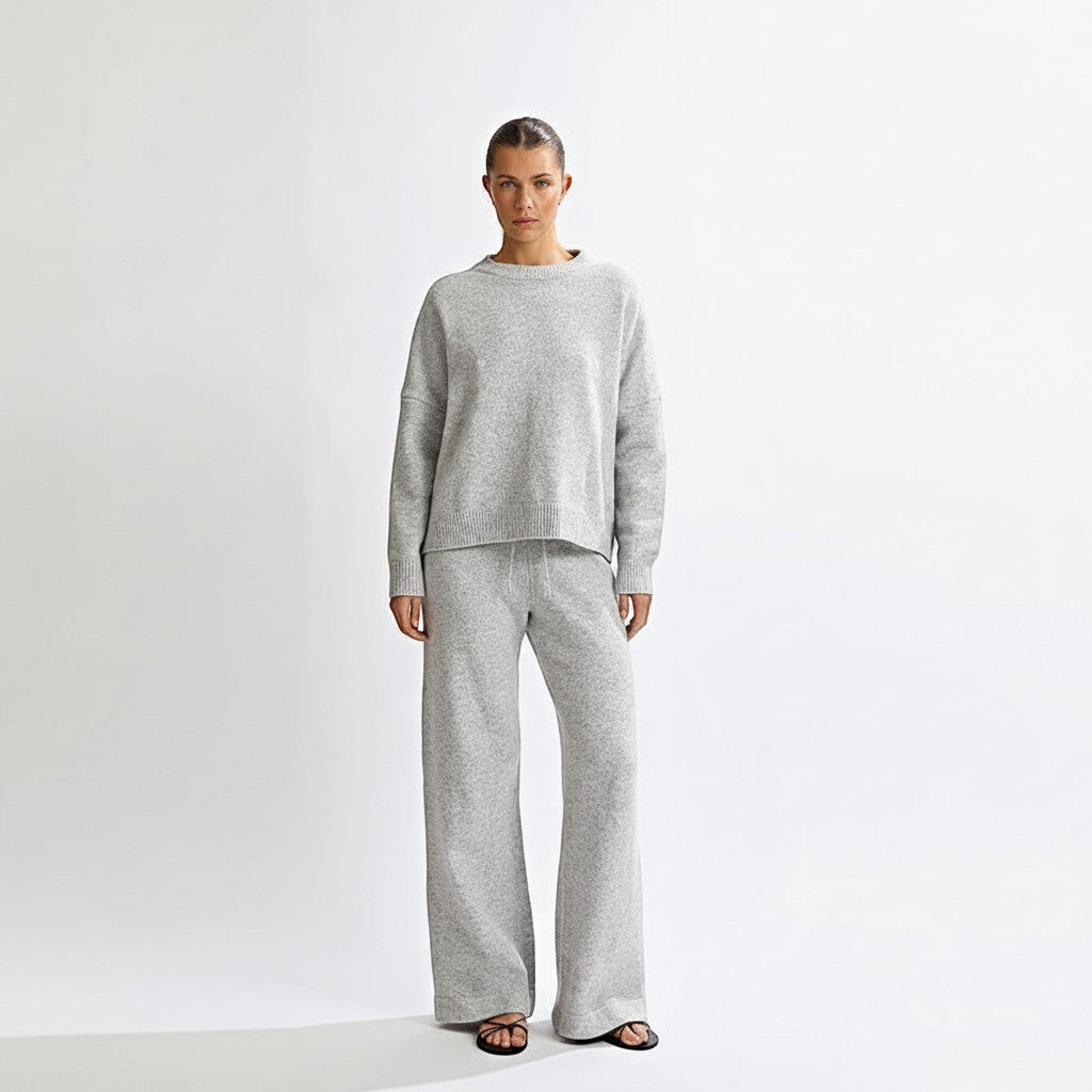 Allzom grey knit sweater with round neck and matching wide-leg pants, featuring a backless detail.
