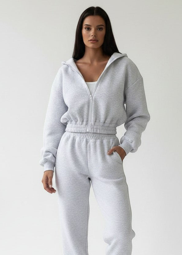 Allzom grey knit hooded zip-up top and ankle-banded pants sports suit on a model.