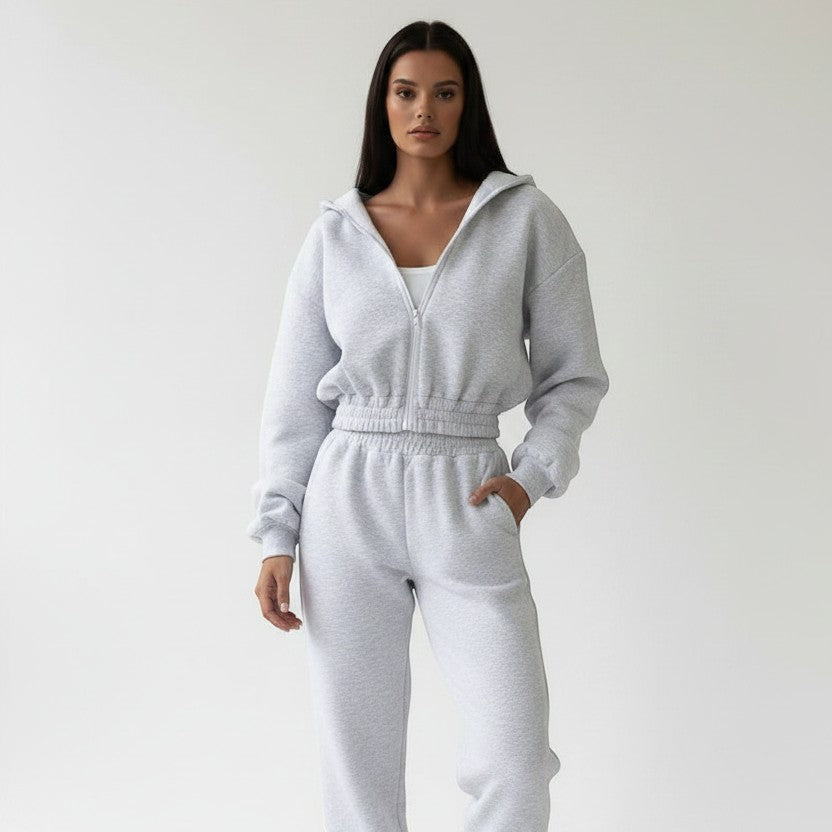 Allzom grey knit hooded zip-up top and ankle-banded pants sports suit on a model.