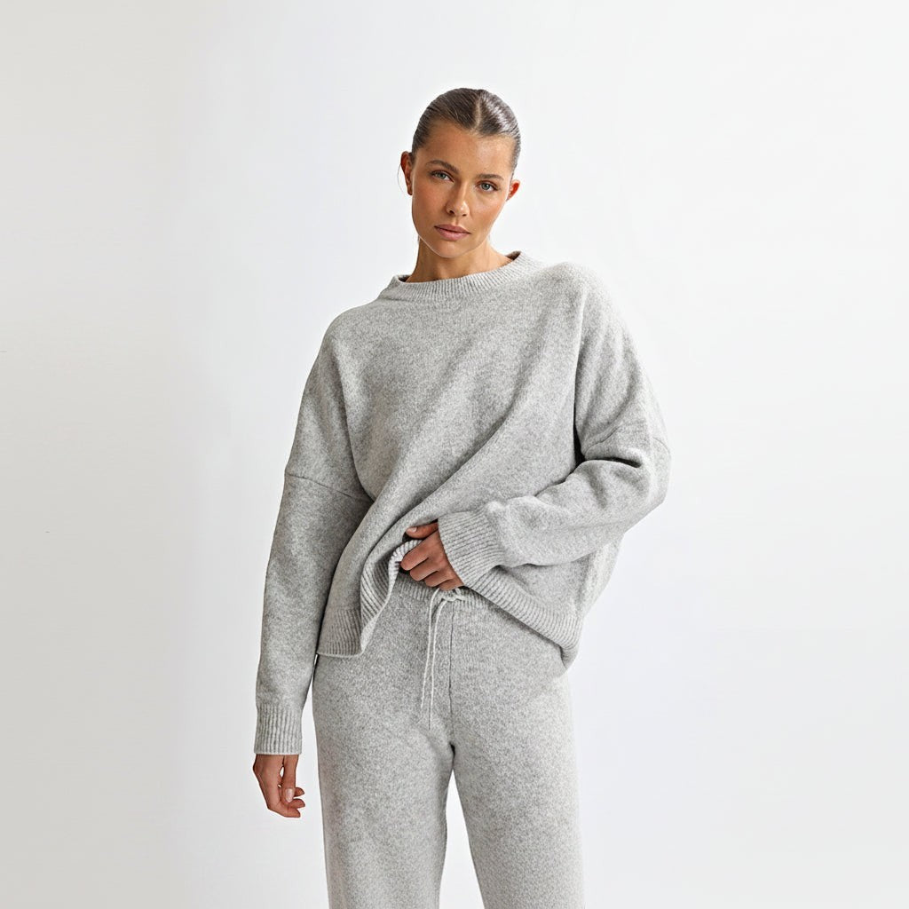 Allzom women's grey knit sweater and pants set with round neck and backless detail. Soft, textured fabric.