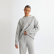 Allzom women's grey knit sweater and pants set with round neck and backless detail. Soft, textured fabric.