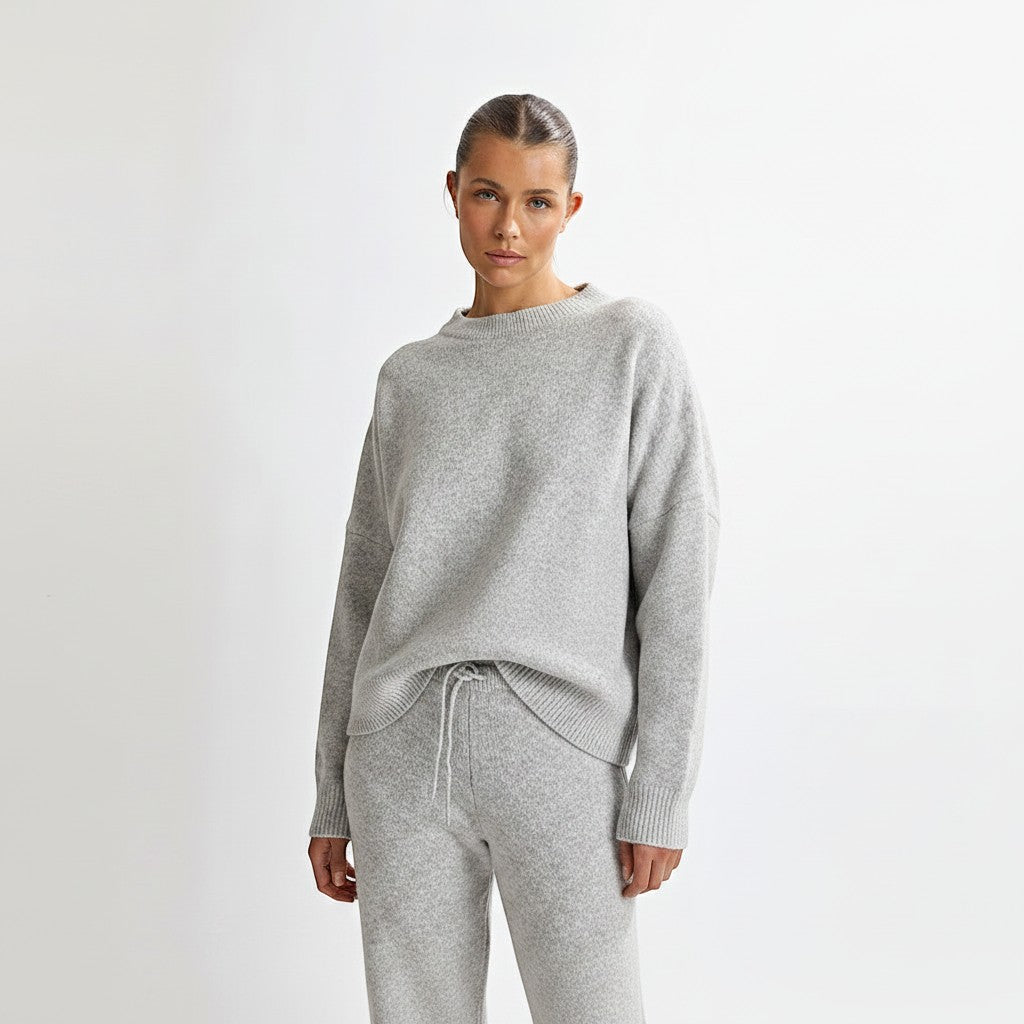 Allzom grey knit sweater with round neck and matching long sleeve pants. Backless detail.