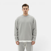 Allzom Men's grey round neck knit sweater with a loose fit, layered over a white t-shirt.