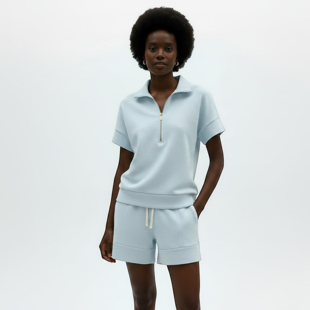 Allzom women's light blue short sleeve zip-neck sweatshirt and matching shorts set. Textured fabric.