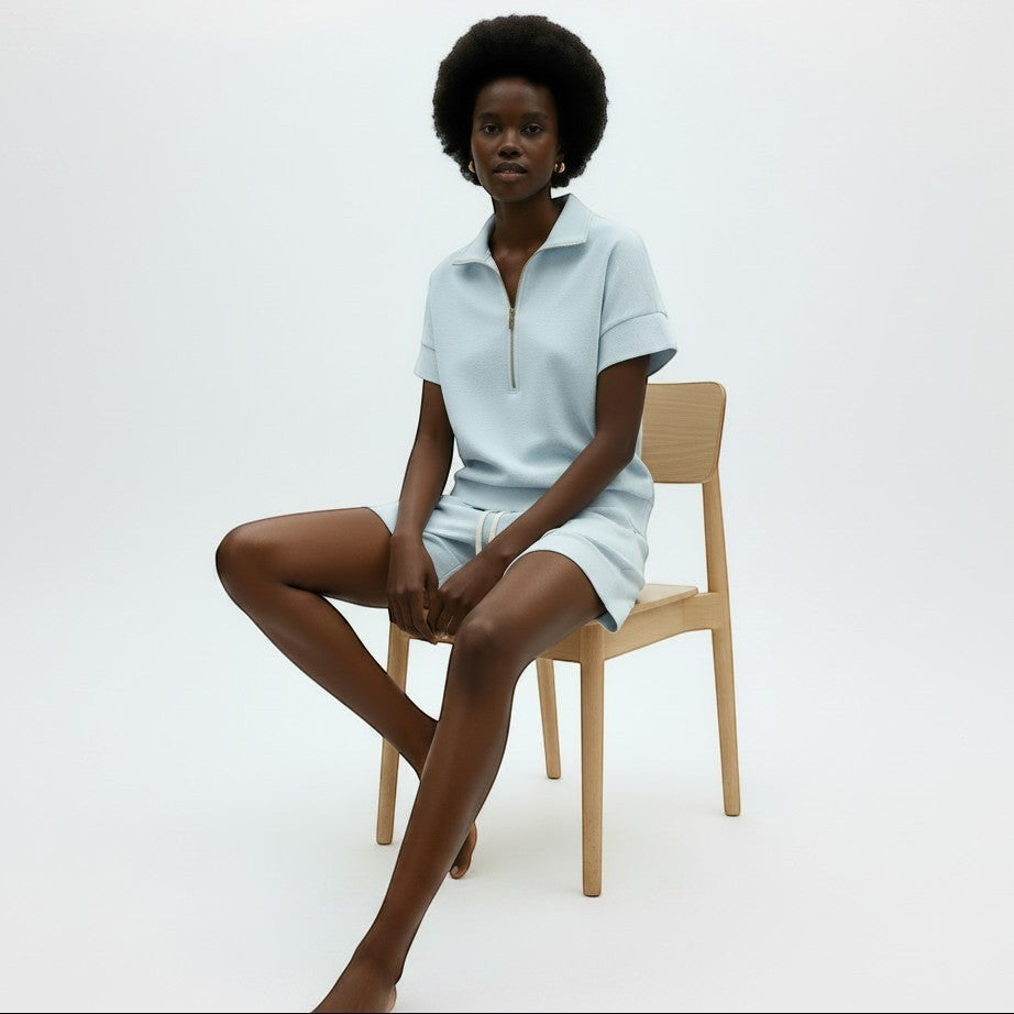 Allzom women's light blue short sleeve zip-neck sweatshirt and matching shorts two-piece set.