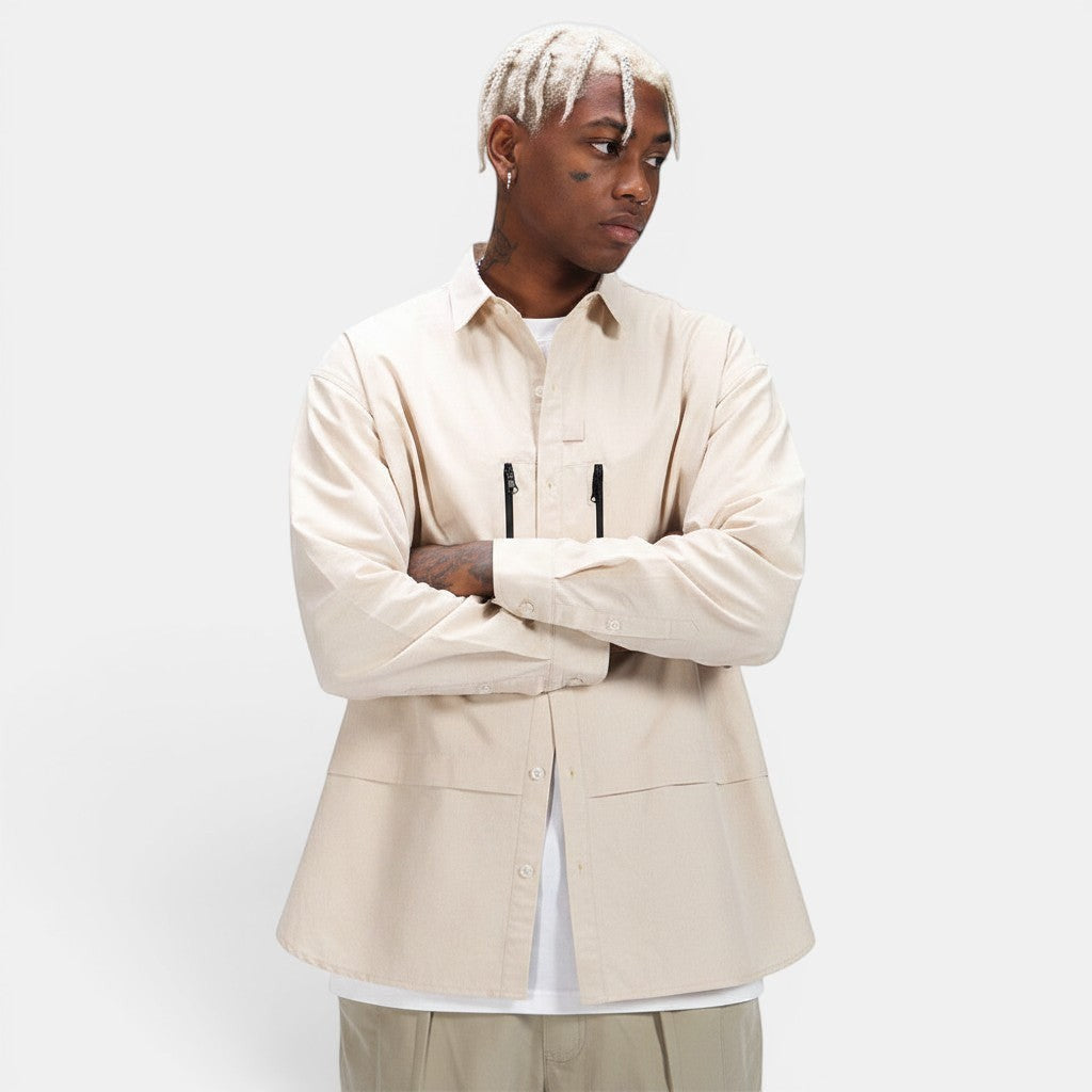Allzom men's beige long-sleeve shirt jacket with zipper pockets and button closure. Lightweight layering piece.