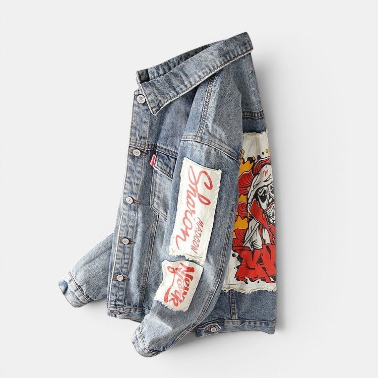 Allzom Men's light wash denim jacket with graphic patches on the sleeve, ideal for spring and autumn.