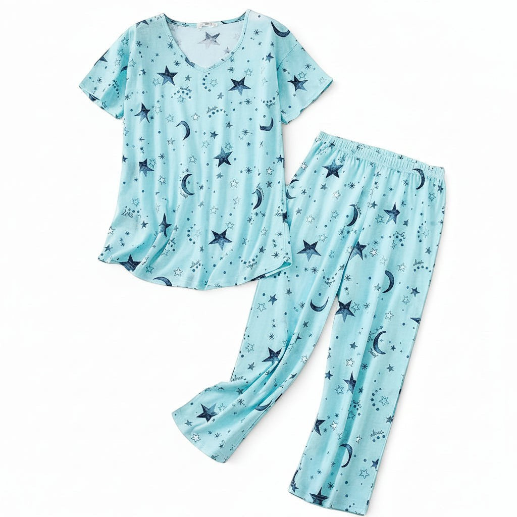 Allzom women's plus size light blue knitted cotton pajama set with short sleeves and cropped pants, featuring a celestial print of stars and moons.