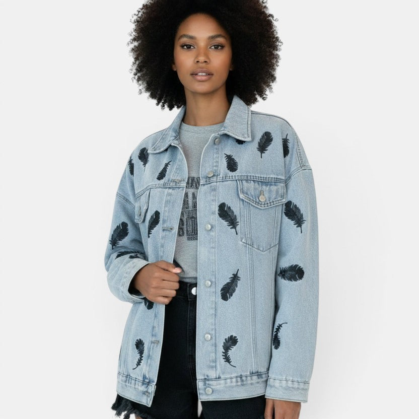 Allzom light blue denim jacket with black feather print, lapel collar and loose fit.