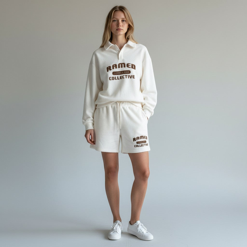 Allzom white corduroy long-sleeve sweater with a polo collar and embroidered logo. Relaxed fit, ideal for casual wear.